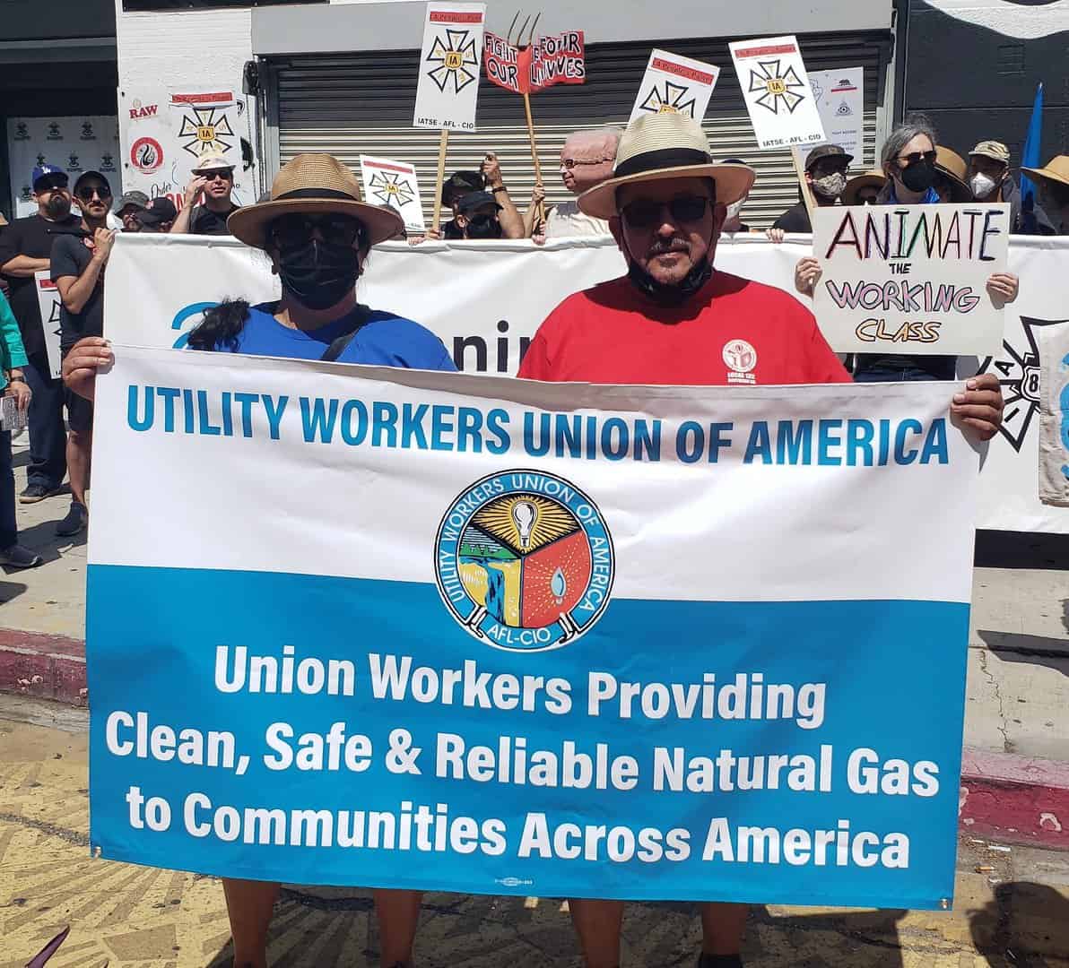 Two Local 132 members holding the UWUA banner: Union Workers Providing Clean, Safe and Reliable Natural Gas to Communities Across America